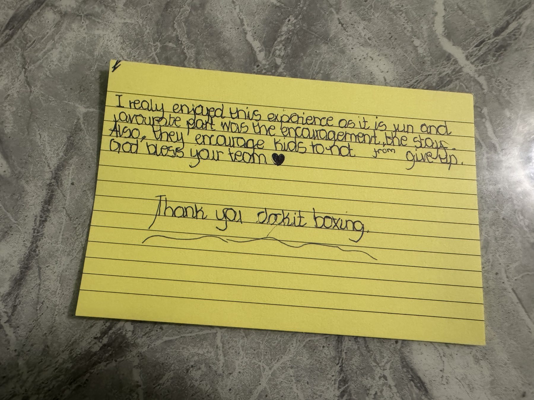 Handwritten feedback card: I really enjoyed this experience as it is fun and my favourite part was the encouragement from the staff. Also, they encourage kids to not give up. God bless your team. Thank you ClockiT Boxing.
