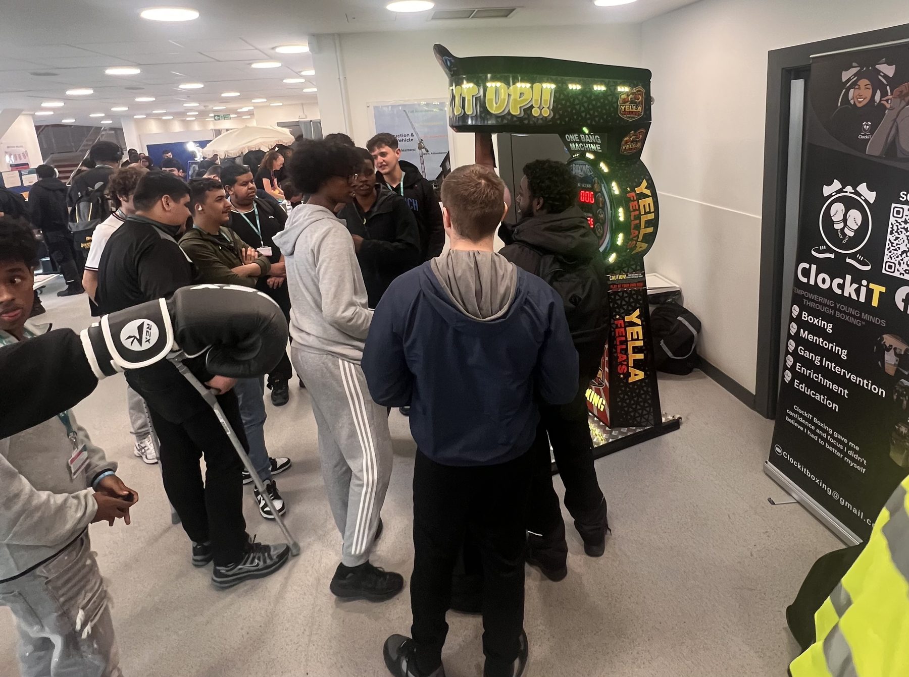 Group of young people practising boxing stances in a hall during a ClockiT workshop