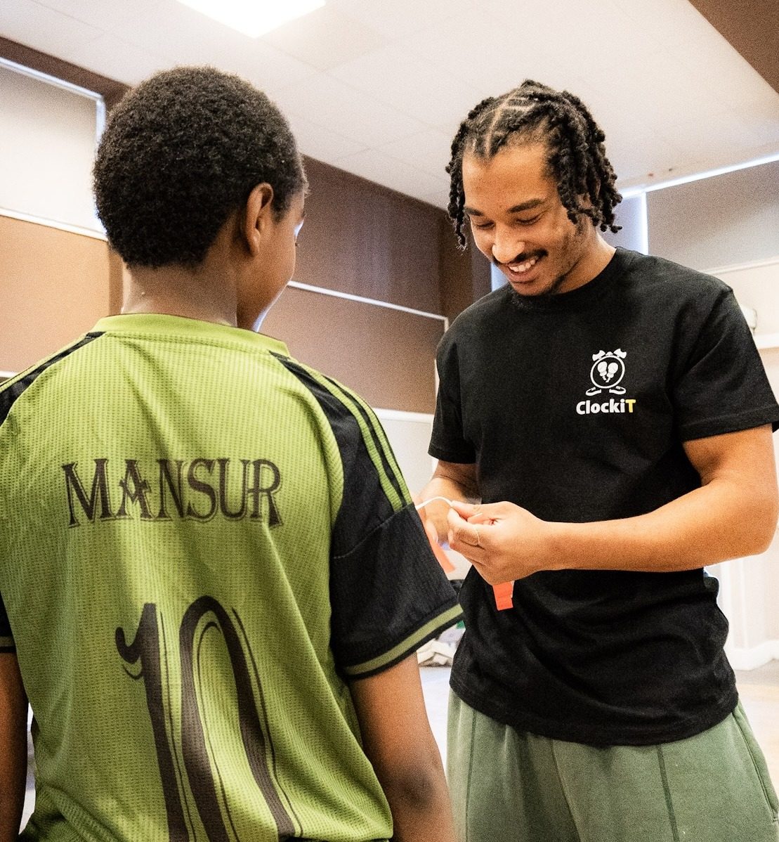 ClockiT coaches with young participants at the end of a session