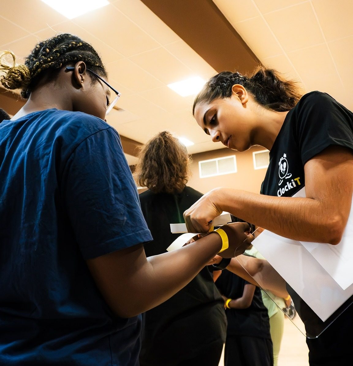 Smiling young participant in a ClockiT t-shirt at a community session