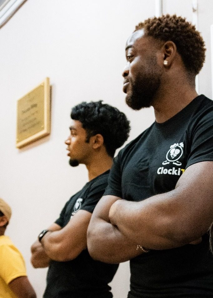 ClockiT coach guiding a young person through boxing technique